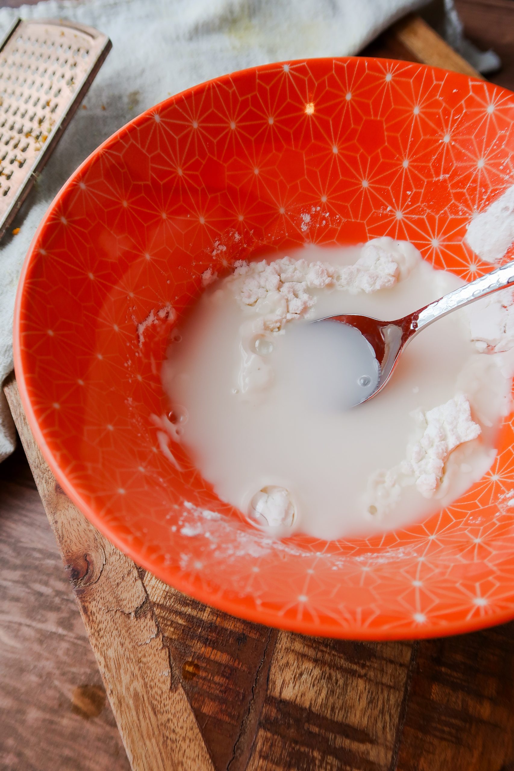 A cornstarch slurry in a bowl, which will be used to thicken homemade orange chicken sauce