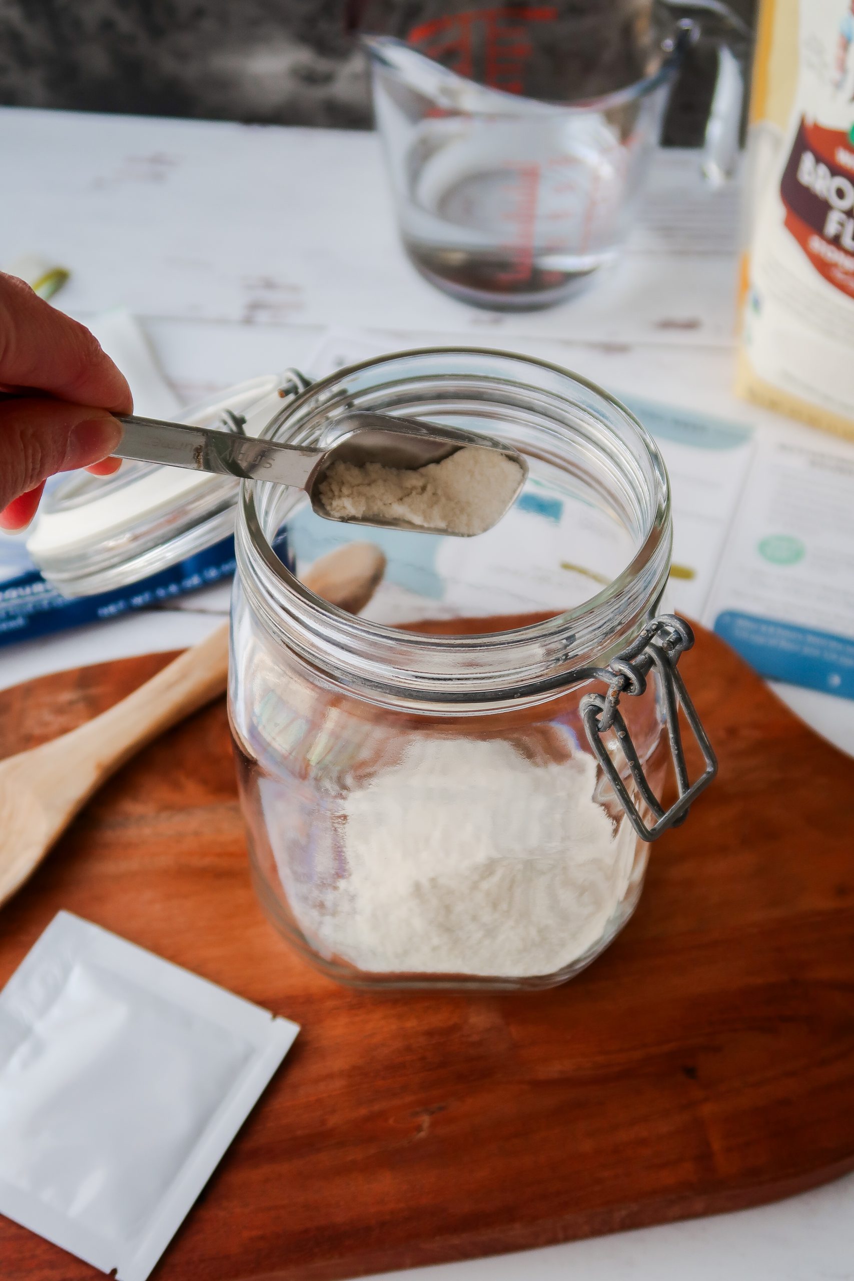 Putting 1 tablespoon of flour into a jar to make a gluten free sourdough starter. Wonders of Cooking