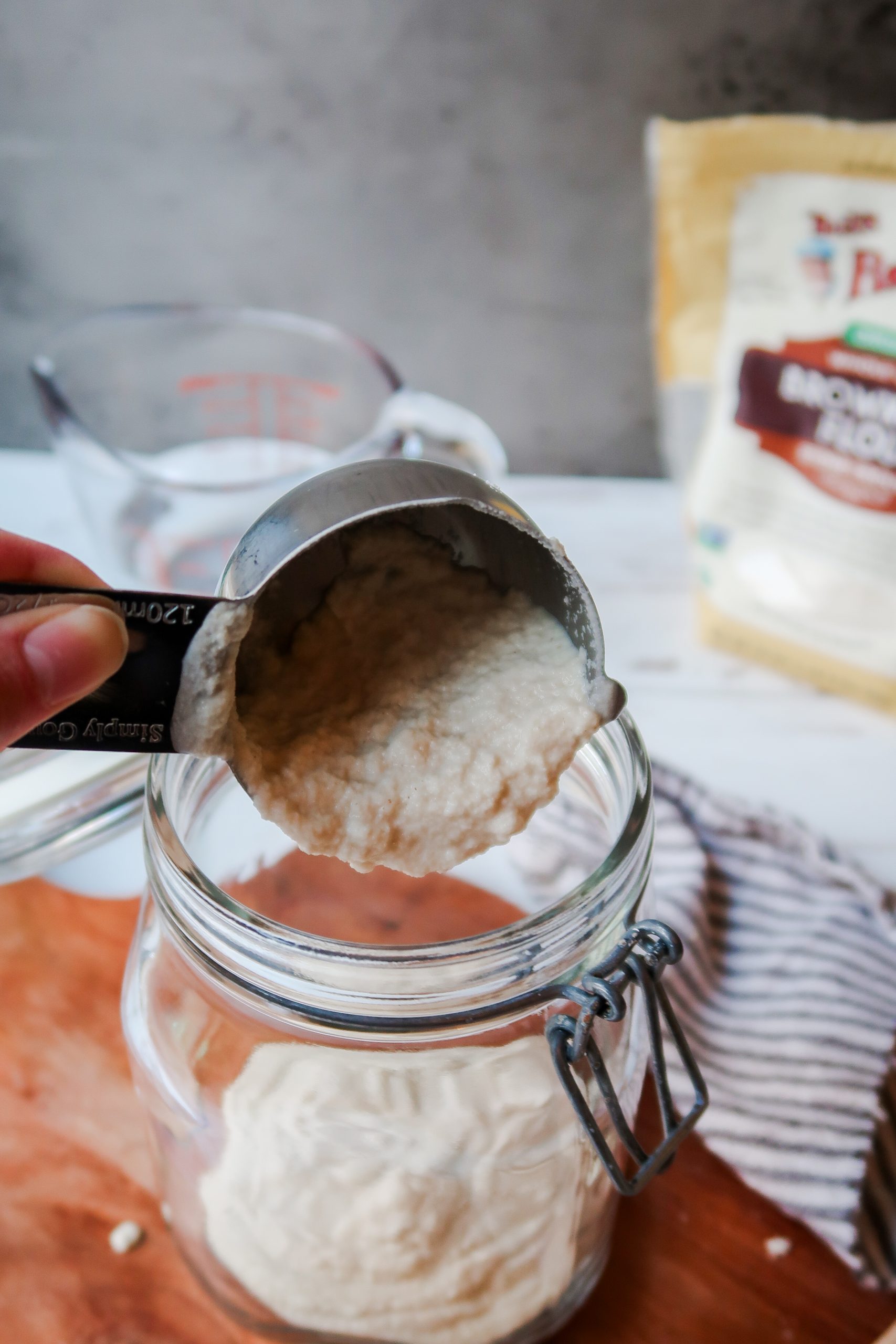 Adding ½ cup of sourdough starter into a clean jar